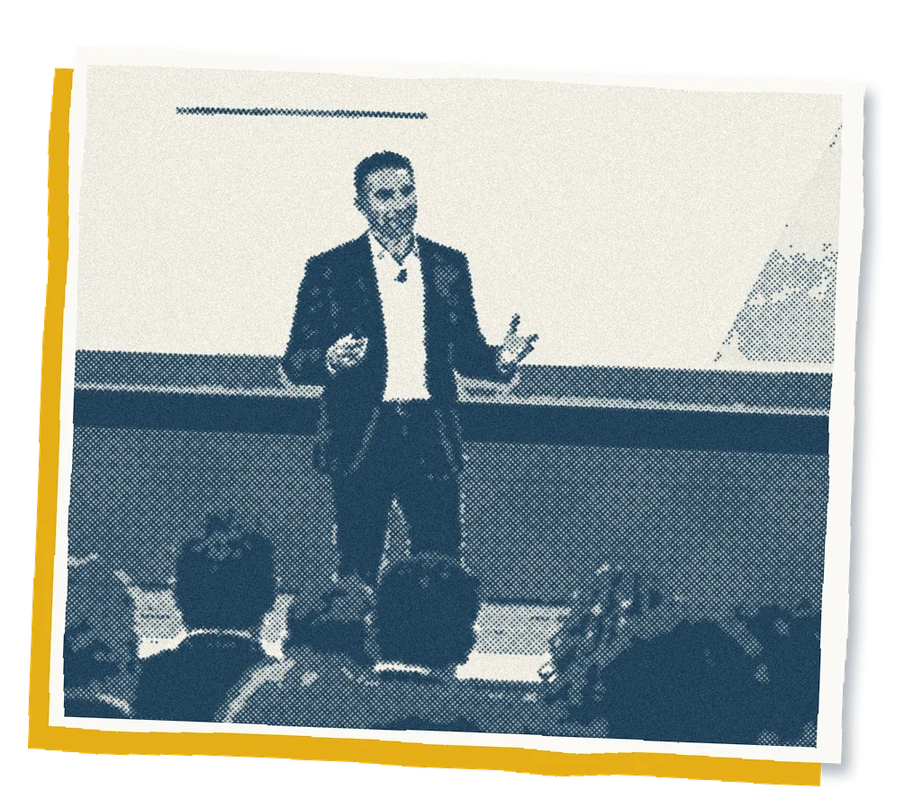 Mikael Mourey speaking in front of an auditorium